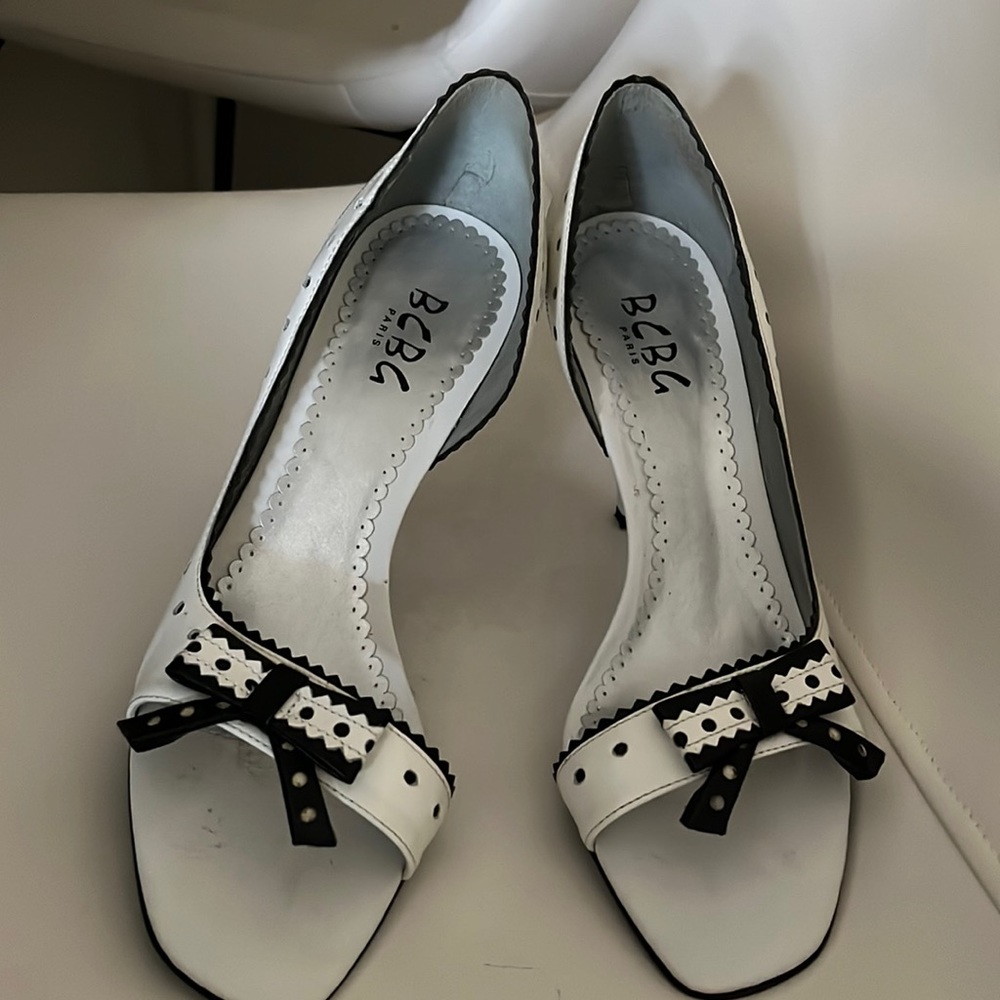 Beautiful white toe out pumps. Width is medium, fit like a narrow..worn once.